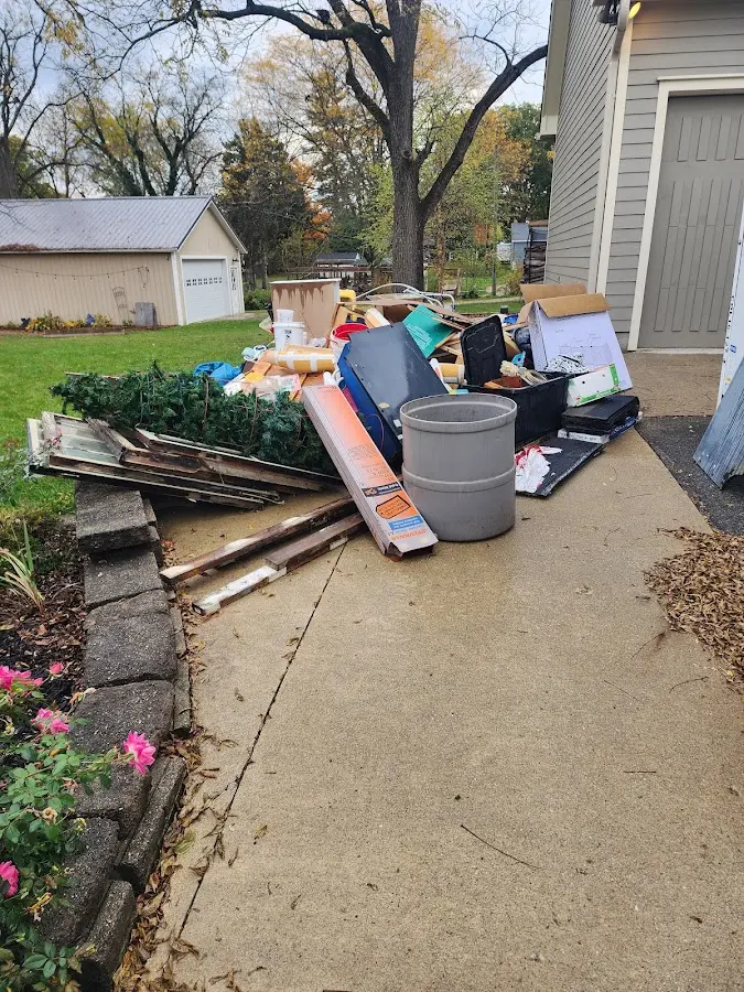 Dumpster being loaded with debris for Roofing Dumpster Rental in Cornelius